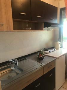 a kitchen with a sink and a counter top at Studios on the Beach in Skala Sotiros