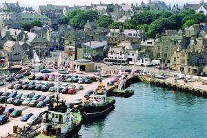 two boats docked in a harbor in a city at 16 Mounthooly Street in Lerwick