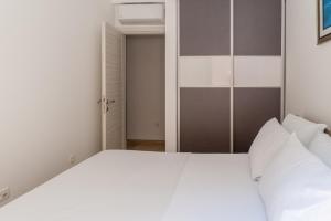 a bedroom with a white bed and an open door at Minka in Kotor +29 photos