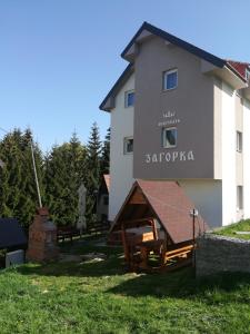 a building with a sign on the side of it at Villa Zagorka and mountain houses A, M, D in Kopaonik