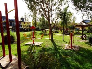 a park with a playground with a swing set at Complejo Turistico Los Troncos in San Rafael