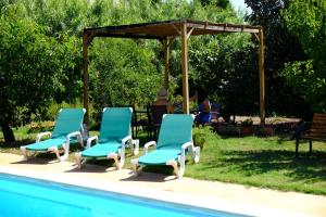 a group of chairs sitting next to a pool at TURISMe RURAL EMPORDA in Torroella de Montgrí