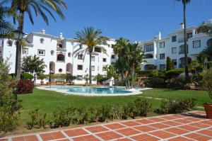 a resort with a swimming pool in front of a building at Puebla Agata in Marbella