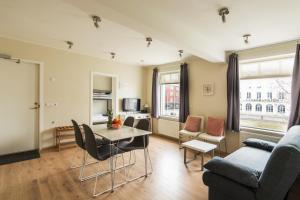 a living room with a couch and a table at Acco Town Square Apartments in Akureyri