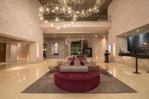 a lobby with a couch and chairs and a chandelier at Victoria Ejecutivo in Guadalajara