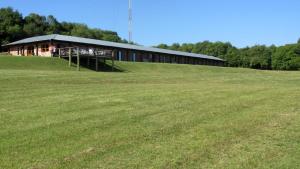 a large building on top of a grass field at Hostería La Bordona in Rivera