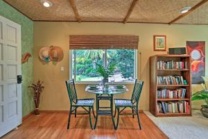 a dining room with a table and chairs and a window at The Great Kona Escape in Kailua-Kona