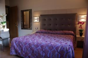 Postel nebo postele na pokoji v ubytování Hotel Michela