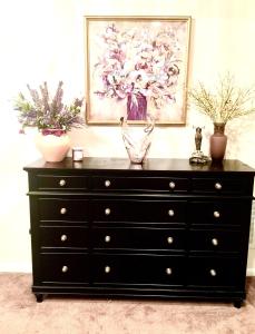 a black dresser with two vases on top of it at Premier National Harbor House in Fort Washington