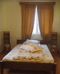 a bed in a bedroom with a window at Lary Hostel in Suceava