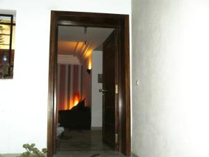 an open door to a living room with a fireplace at Happy House Ennasr in Ariana