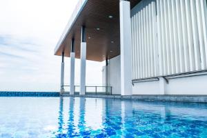 a swimming pool in front of a building at Damen Subang by Widebed in Subang Jaya