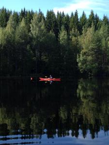 a small boat floating on top of a body of water at Kyykerin Kartano in Outokumpu