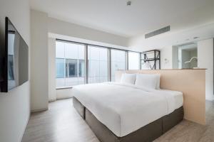 Postel nebo postele na pokoji v ubytování amba Taipei Songshan
