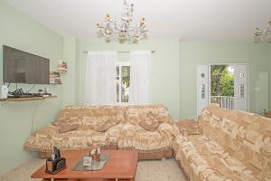 a living room with a couch and a table at Nissi Maria Villa in Ayia Napa