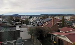 a view of a city with buildings and mountains at Prince Of Wales Hotel in Hobart