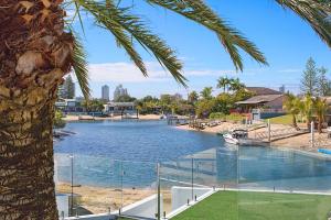 a large swimming pool with a boat in the water at Coastal Elegance in Gold Coast