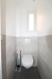 a bathroom with a white toilet and a window at Appartement T2 sur le port de sanary in Sanary-sur-Mer