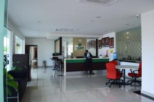 a person standing at a counter in a room at Hotel Desaru Penawar in Desaru