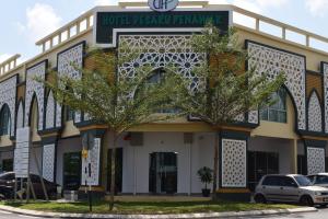 a building with trees in front of it at Hotel Desaru Penawar in Desaru
