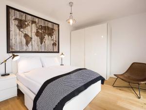 a bedroom with a bed with a map on the wall at VacationClub - Przy Plaży Apartment 23 in Mielno