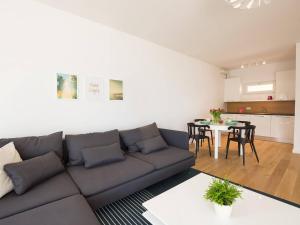 a living room with a couch and a table at VacationClub - Przy Plaży Apartment 23 in Mielno