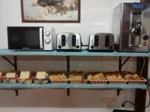 a shelf with breads and a microwave on it at Albergue Cabrales in Carreña de Cabrales