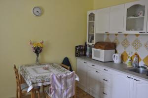 a kitchen with a table and a microwave at Lately renovated country house in Trenčín