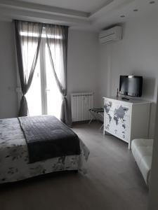 a bedroom with a bed and a tv and a window at Settimo Cielo in Florence