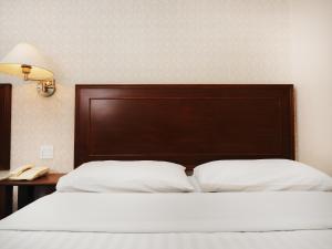 Postel nebo postele na pokoji v ubytování Sun Inns Hotel Subang