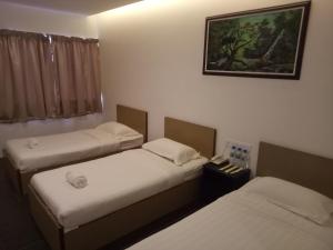 Postel nebo postele na pokoji v ubytování Hotel Sri Bernam