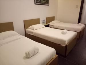 Postel nebo postele na pokoji v ubytování Hotel Sri Bernam