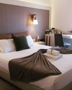a hotel room with a bed and two nightstands at Platia in Fira