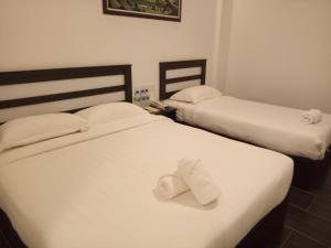 Postel nebo postele na pokoji v ubytování Hotel Sri Bernam