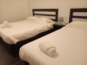Postel nebo postele na pokoji v ubytování Hotel Sri Bernam