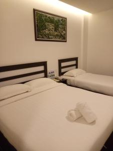 Postel nebo postele na pokoji v ubytování Hotel Sri Bernam