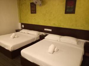 Postel nebo postele na pokoji v ubytování Hotel Sri Bernam