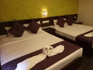 Postel nebo postele na pokoji v ubytování Hotel Sri Bernam
