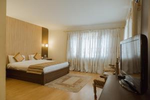 Posteľ alebo postele v izbe v ubytovaní Hotel Vaishali