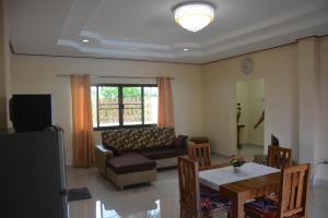 a living room with a couch and a table at Apple Bungalows in Bang Saphan