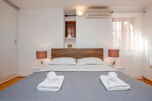 a bedroom with a bed with two towels on it at Apartment Marconi in Rovinj