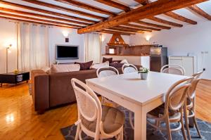 a living room with a table and a couch at Apartment Marconi in Rovinj