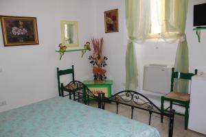 a bedroom with a bed and a table and chairs at Tenuta Santa Rosa in Sannicola +41 photos