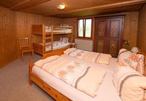 a bedroom with three beds and a bunk bed at Bed and Breakfast Huobschür in Hellbühl