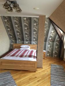 a bedroom with a bed in a attic at Hotel Svitlytsia in Tyachiv +14 photos