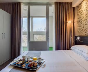 A bed or beds in a room at Best Western Plus Hotel Farnese