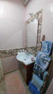 a bathroom with a sink and a mirror at beb "Ziu Antoi e Zia Srivia" in Sestu +30 photos