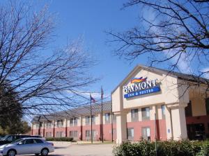 a building with a sign on the front of it at Baymont by Wyndham Lewisville in Lewisville
