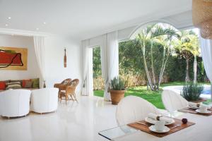 a living room with white furniture and a large window at Villas Espléndida in Adeje