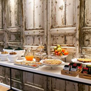 a buffet with many different types of food on a table at B&B La Collegiata in Caltagirone